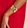 BRAZALETE CROSS LEAF · BAÑO ORO